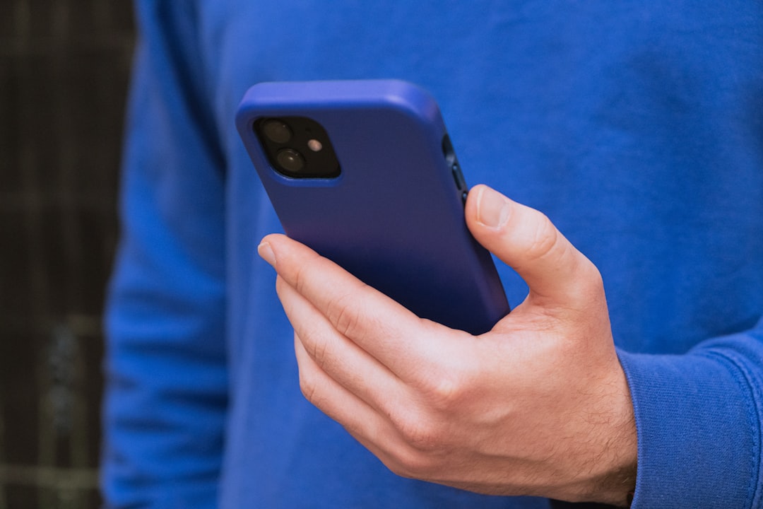 a close up of a person holding a cell phone