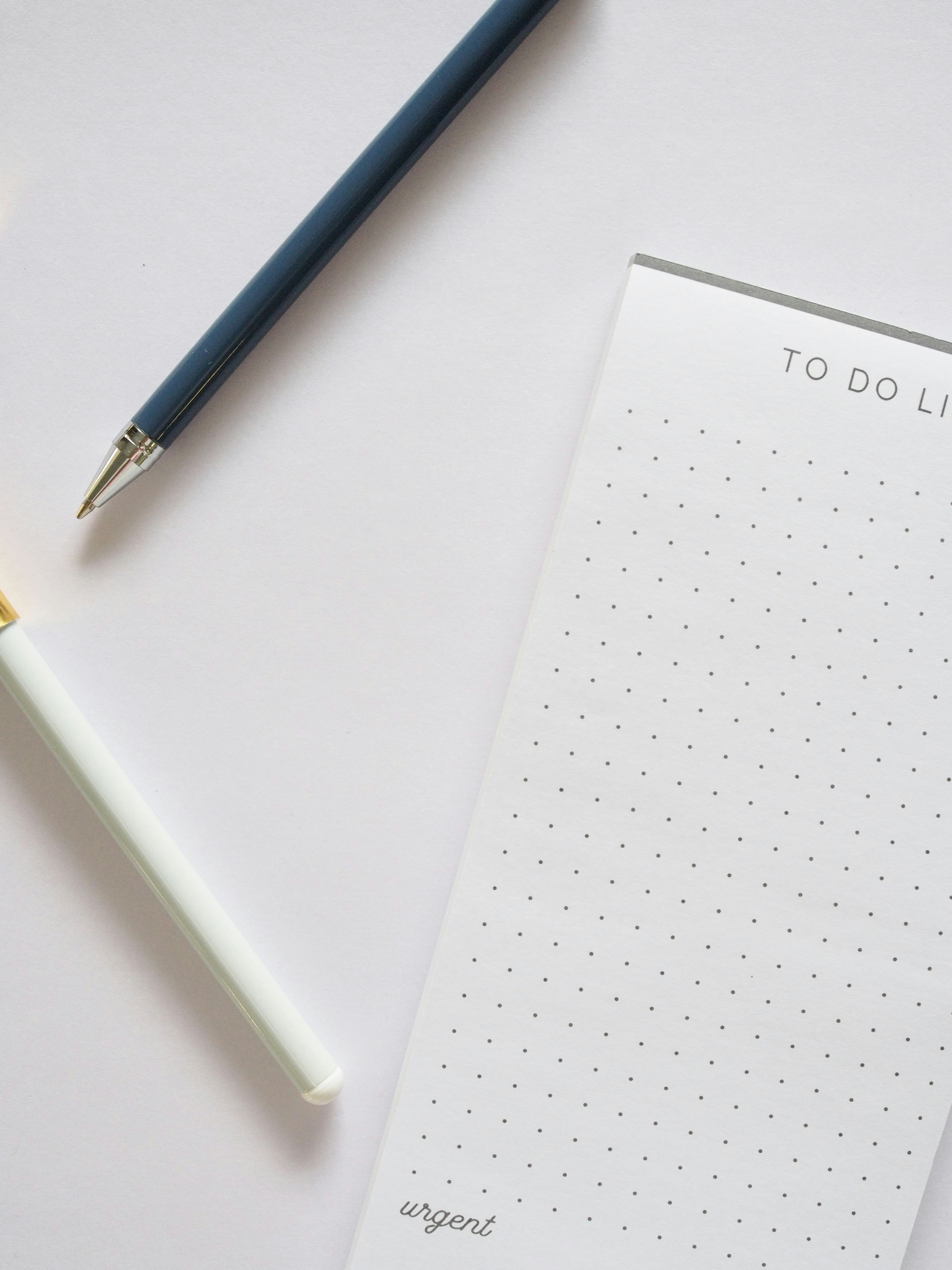 What tasks should I include in my daily checklist? by Daily Checklist A notepad with a pen next to it